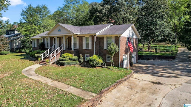 view of front of home with a front yard, a garage, and covered porch