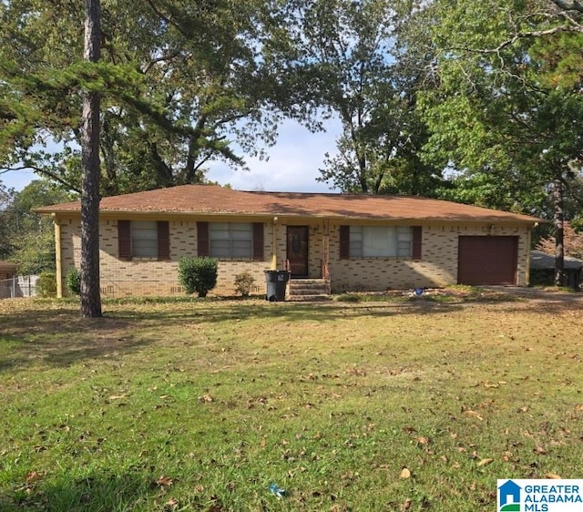 single story home with a garage, brick siding, and a front lawn