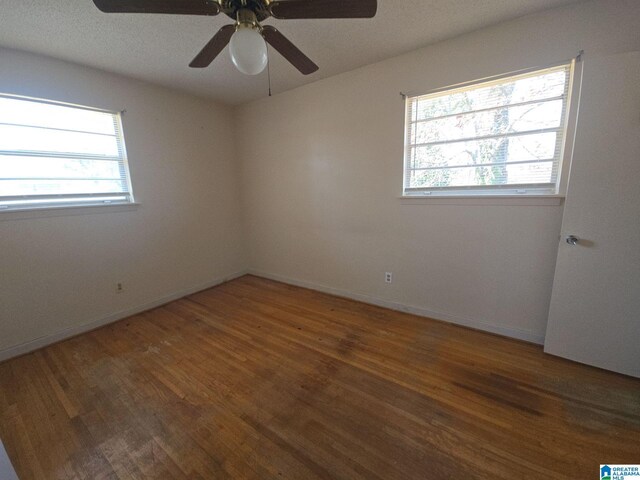 empty room featuring dark wood finished floors and baseboards