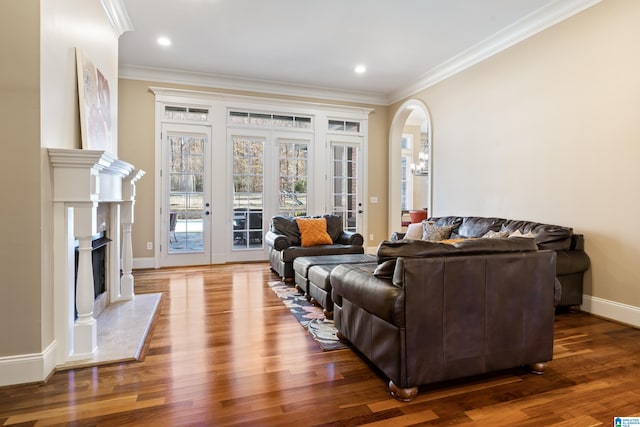 living room with dark wood-type flooring and ornamental molding