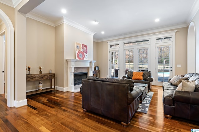 living room featuring ornamental molding and dark wood-type flooring