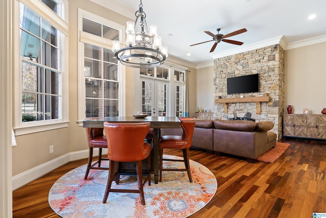 dining room with a fireplace, crown molding, dark wood-type flooring, and french doors