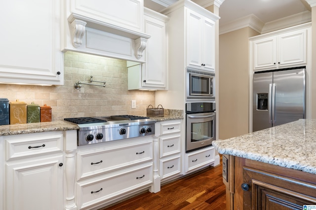 kitchen featuring appliances with stainless steel finishes, dark hardwood / wood-style floors, white cabinetry, and light stone counters