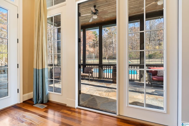 entryway with hardwood / wood-style floors, a wealth of natural light, wooden ceiling, and ceiling fan