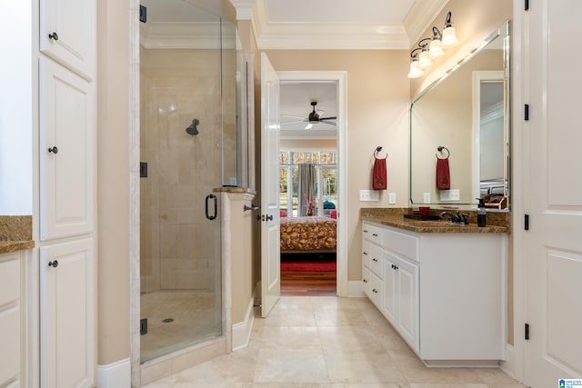 bathroom featuring ceiling fan, a shower with shower door, crown molding, and vanity