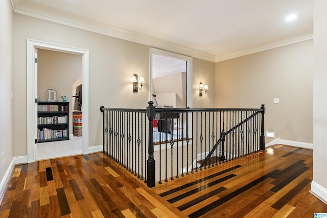 corridor with hardwood / wood-style floors and crown molding