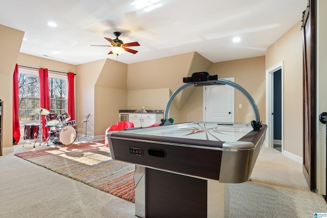 game room featuring light colored carpet and ceiling fan