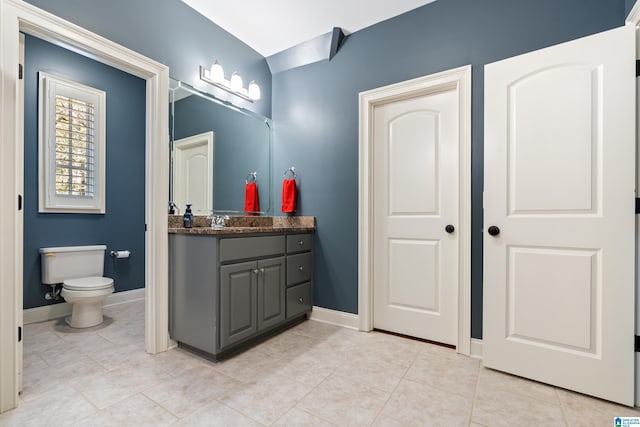 bathroom featuring toilet, vanity, and tile patterned floors