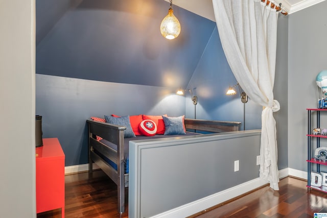 bedroom featuring dark hardwood / wood-style floors, vaulted ceiling, and crown molding