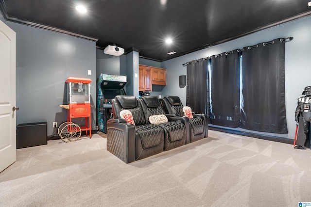 home theater room featuring light colored carpet and ornamental molding