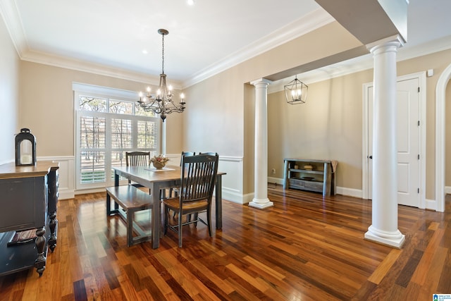 dining room featuring dark hardwood / wood-style flooring, ornamental molding, and an inviting chandelier