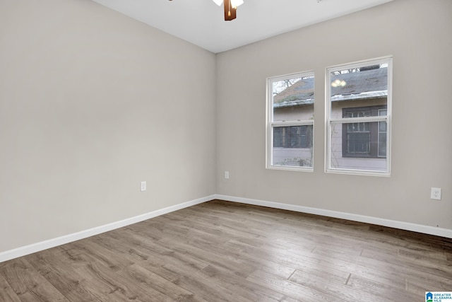 unfurnished room featuring ceiling fan and light wood-type flooring