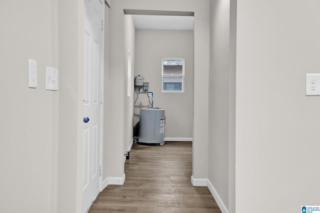 hallway featuring water heater and light hardwood / wood-style floors