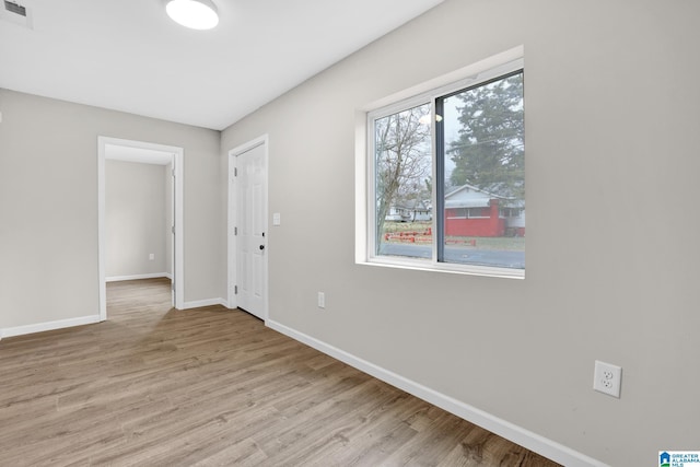 spare room featuring light wood-type flooring