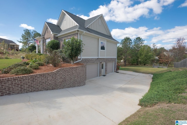 view of property exterior with a garage and a lawn