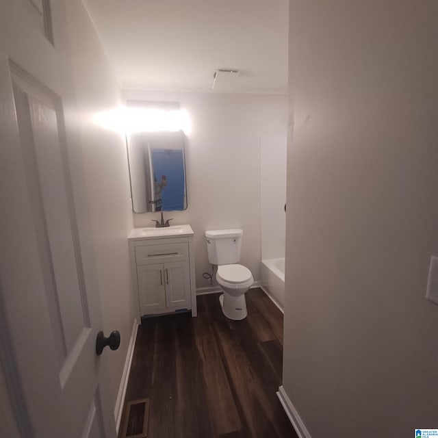 bathroom featuring hardwood / wood-style floors, vanity, and toilet