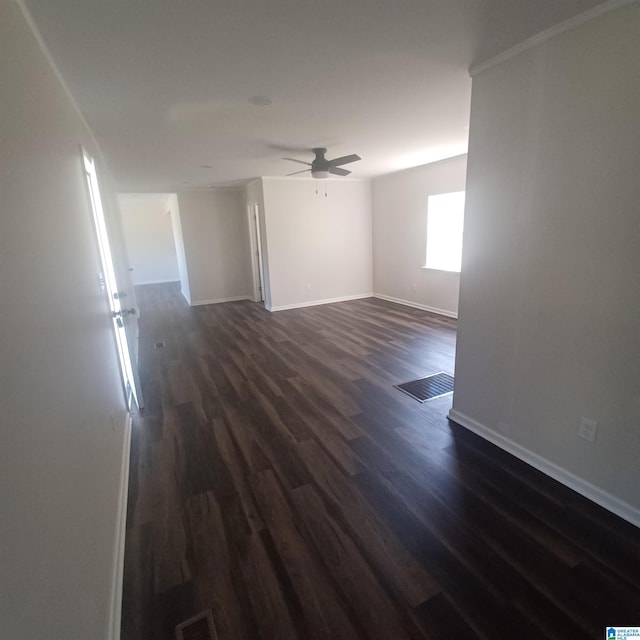 spare room with ceiling fan and dark wood-type flooring