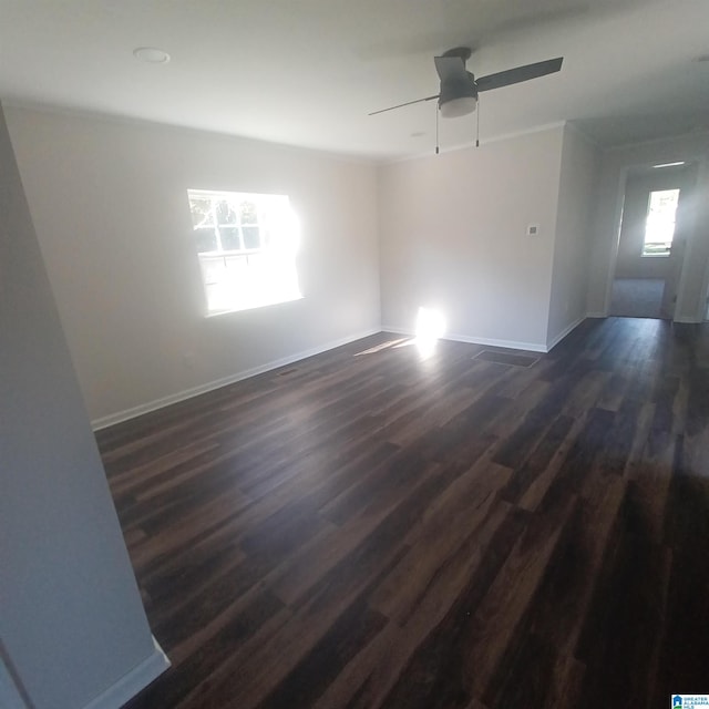 unfurnished room featuring ceiling fan and dark hardwood / wood-style flooring