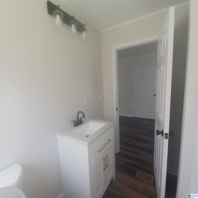 bathroom featuring vanity, hardwood / wood-style flooring, and toilet