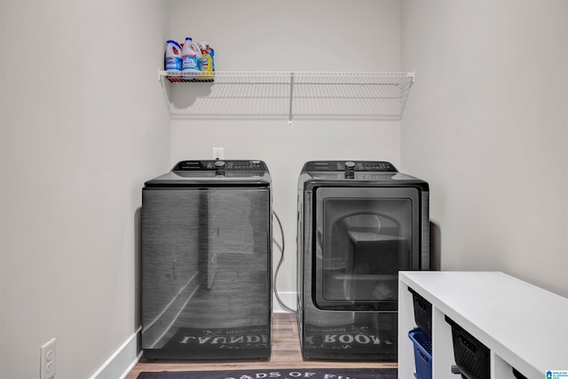 laundry room featuring washer and clothes dryer and hardwood / wood-style floors