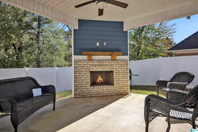 view of patio with an outdoor brick fireplace and ceiling fan