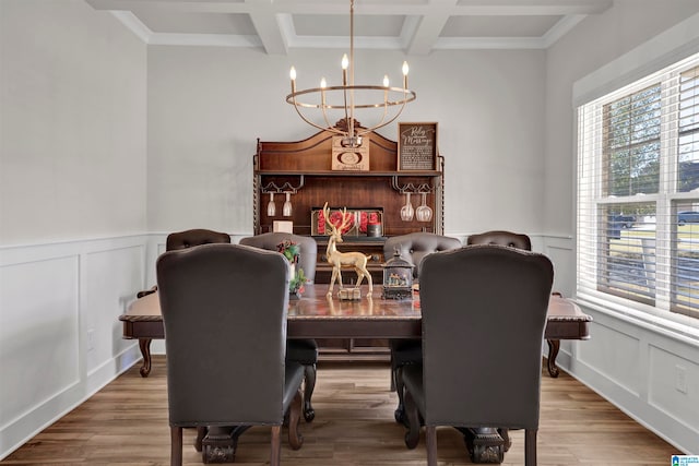 dining area featuring coffered ceiling, an inviting chandelier, beamed ceiling, wood-type flooring, and ornamental molding