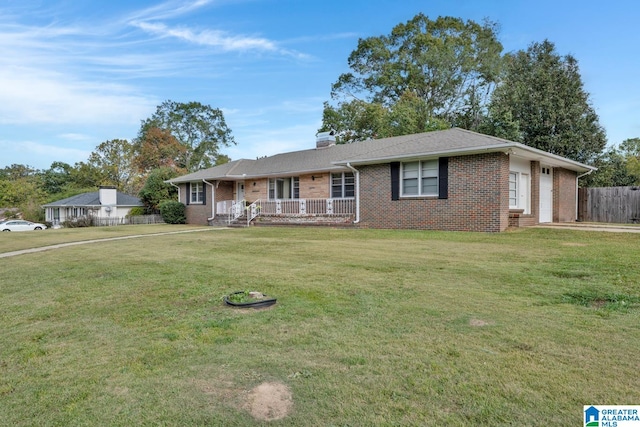 single story home featuring a front yard, a porch, and a garage