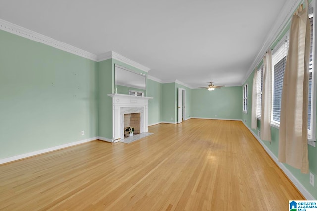 unfurnished living room with ceiling fan, crown molding, and light hardwood / wood-style flooring