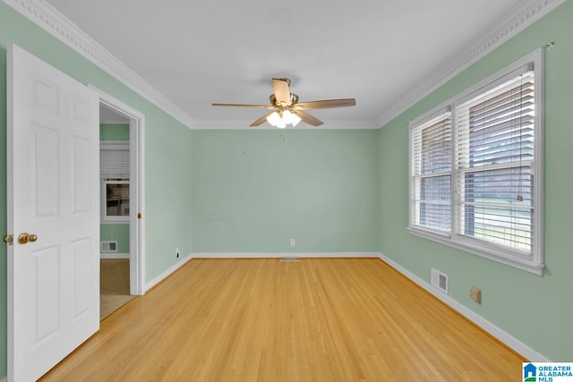 empty room with ceiling fan, light hardwood / wood-style floors, and ornamental molding