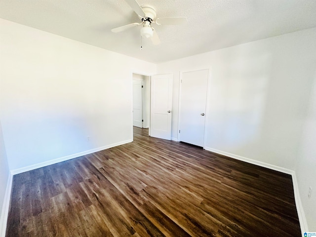 unfurnished bedroom with a textured ceiling, ceiling fan, and dark wood-type flooring