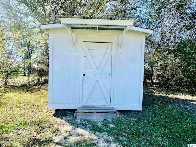 view of outbuilding featuring a yard