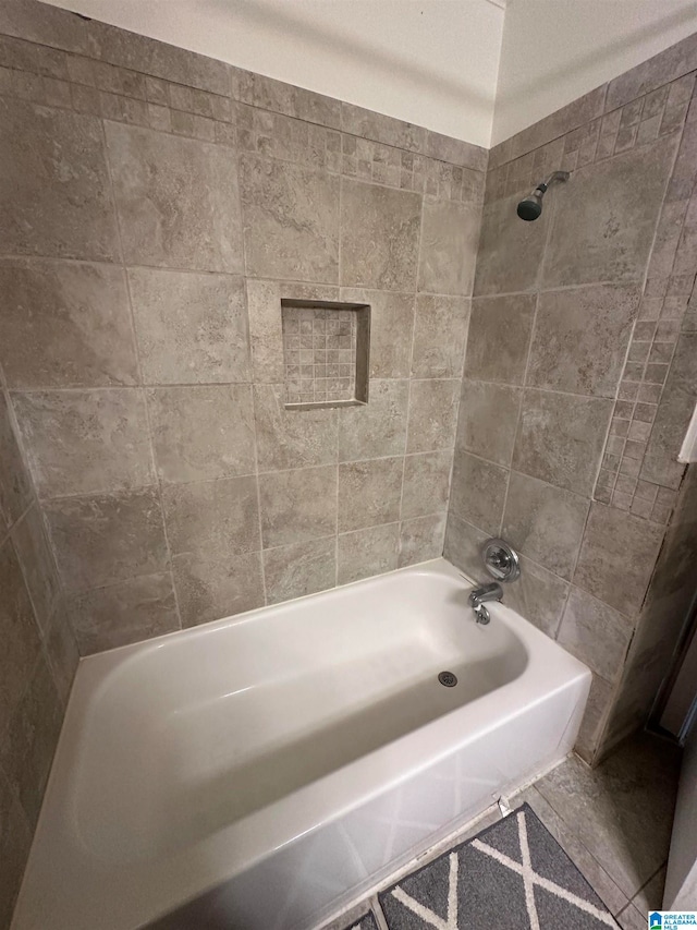 bathroom with tile patterned flooring and tiled shower / bath