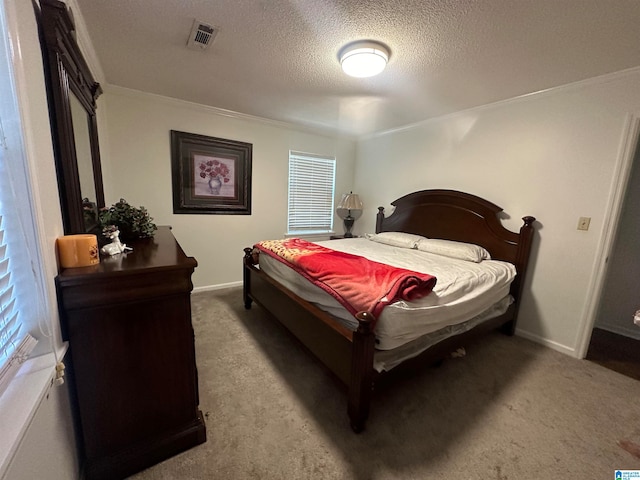 carpeted bedroom featuring ornamental molding and a textured ceiling