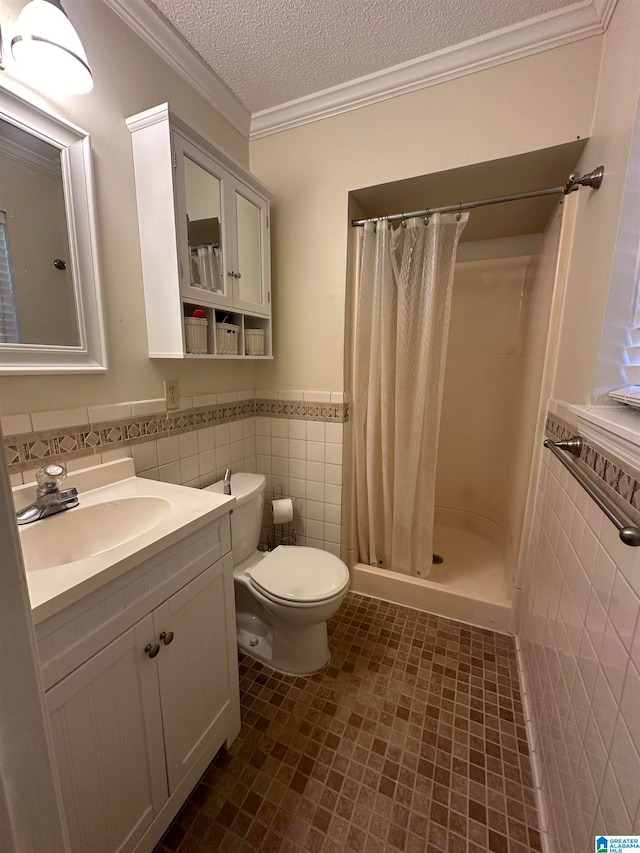 bathroom featuring a textured ceiling, vanity, curtained shower, and tile walls