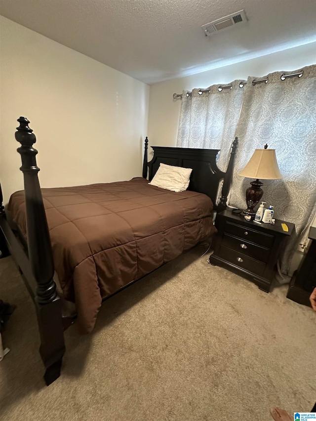 carpeted bedroom with a textured ceiling