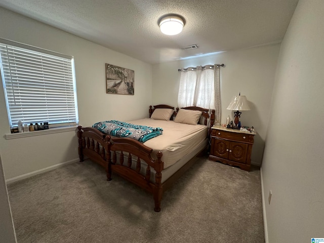 carpeted bedroom featuring a textured ceiling