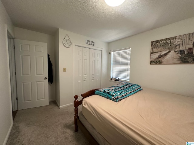 bedroom with carpet, a textured ceiling, and a closet