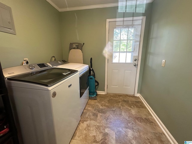 washroom featuring crown molding and washing machine and clothes dryer