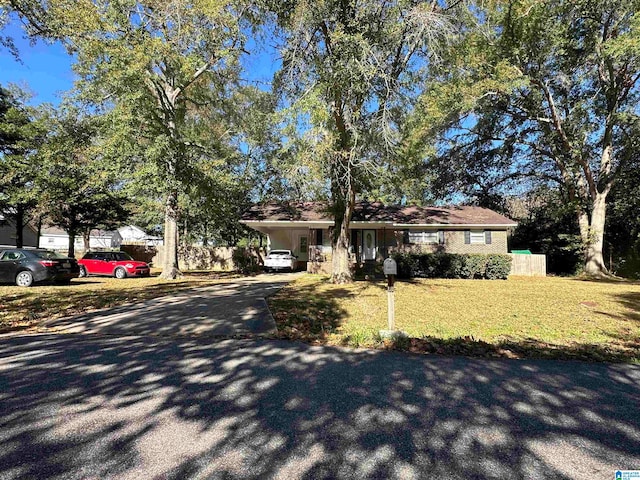 ranch-style home with a front lawn and a carport