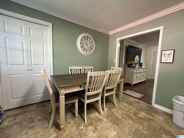 dining space with a textured ceiling and ornamental molding