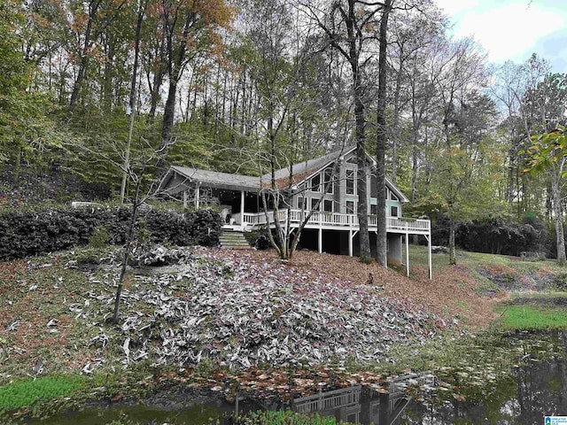 rear view of property with a deck with water view