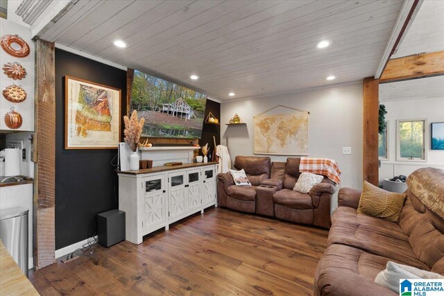 living room with wooden ceiling, dark wood-type flooring, and ornamental molding