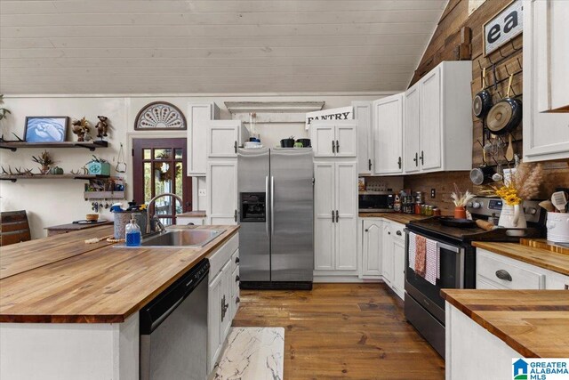 kitchen with white cabinets, appliances with stainless steel finishes, dark hardwood / wood-style flooring, and butcher block countertops