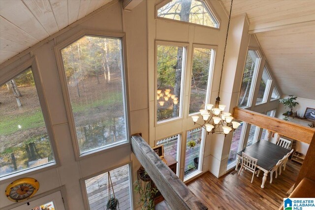 sunroom with wooden ceiling, lofted ceiling, and an inviting chandelier