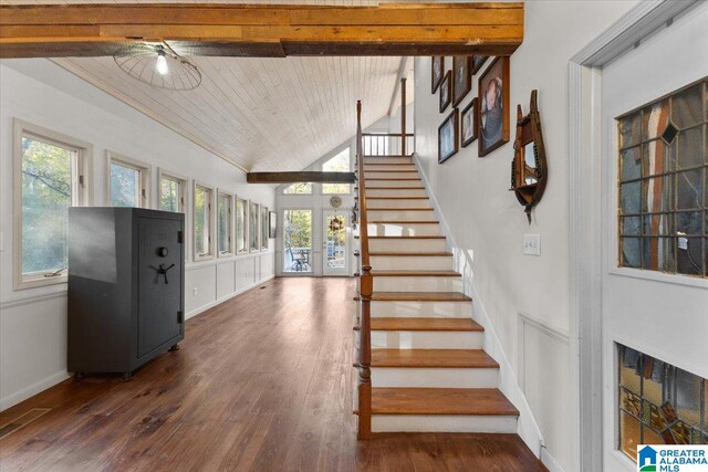 stairway with wood-type flooring, wood ceiling, and french doors