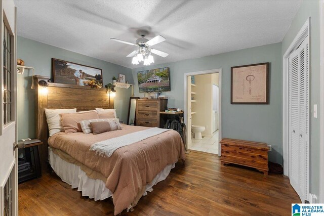 bedroom with a textured ceiling, ceiling fan, a closet, and dark hardwood / wood-style floors