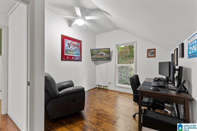 office space with ceiling fan, hardwood / wood-style floors, and vaulted ceiling