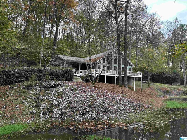 back of house with a deck with water view