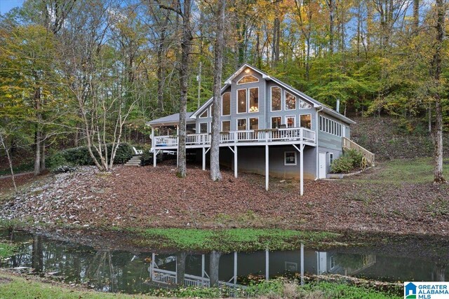 back of house with a deck with water view