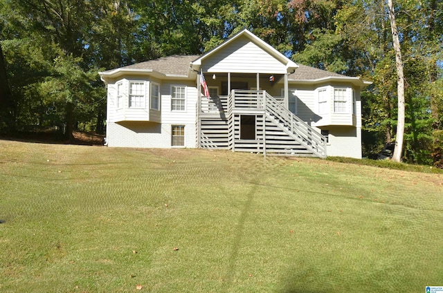 view of front of house featuring a sunroom and a front lawn